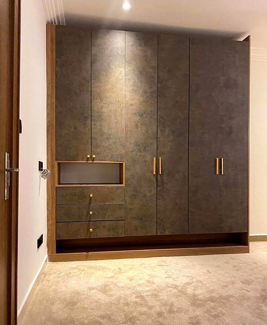Textured wardrobe with brass handles